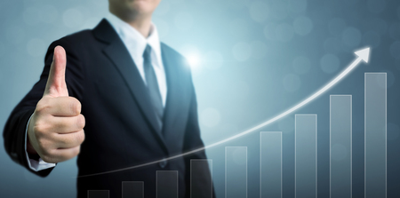 Business development to success and growing growth concept. Businessman showing OK or hand sign thumb up with arrow graph corporate future growth planの写真素材