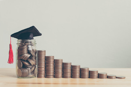 Scholarship money concept. Coins in jar with money stack step growing growth saving money investmentの写真素材
