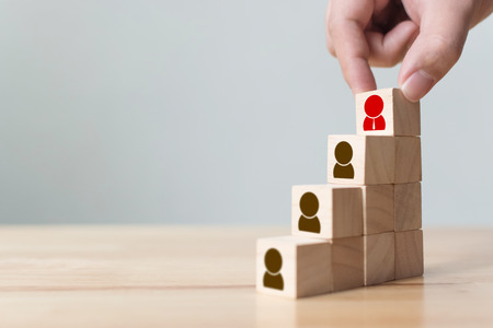 Human resources and talent management and recruitment business concept, Hand putting wood cube block on top staircase, Copy spaceの写真素材