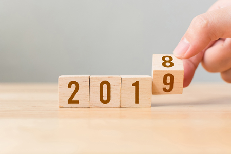 New year 2018 change to 2019 concept. Hand flip over wood cube blockの写真素材
