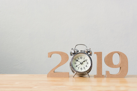 New years resolution 2019 concept. Wooden year number and clock on table with copy space for your textの写真素材