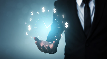 Businessman holding sign clock. Concept business time is moneyの写真素材