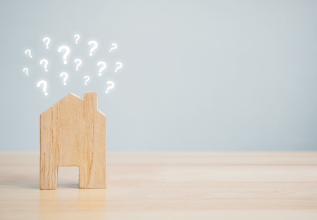 Wooden home shape with question mark on wood table and copyspace for your text. Ideas house conceptの写真素材