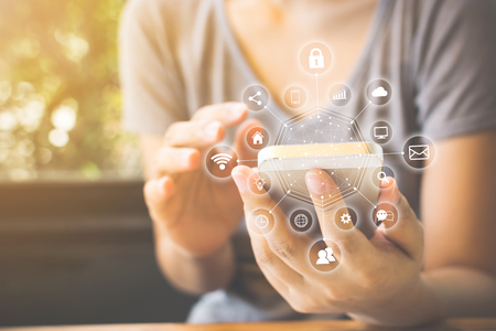 Asian woman hand using smartphone with icon technology communication and internet of things (IOT). Innovative convenience smart life conceptの写真素材