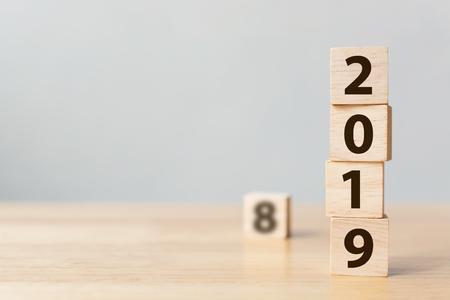 New year 2018 change to 2019 concept. Wooden block cube with number on tableの写真素材