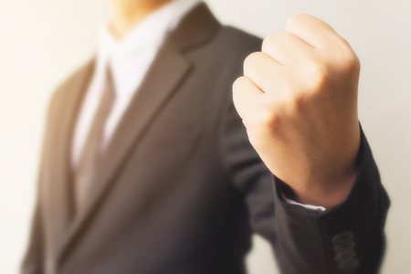 Businessman hand showing fist sign gesture. Fighting or victory conceptsの写真素材