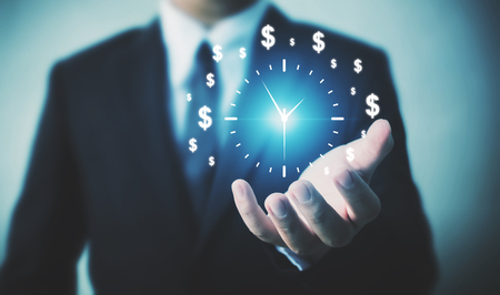 Businessman holding sign clock. Concept business time is moneyの写真素材