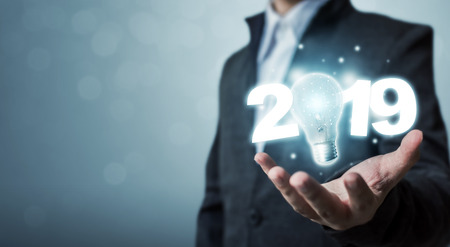 Businessman hand holding light bulb with year 2019 idea innovation technology conceptの写真素材