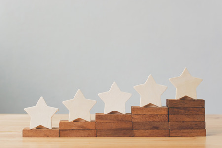 Wooden five star shape on table. The best excellent business services rating customer experience conceptの写真素材