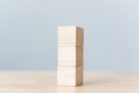Wood block stacking on top with wooden table. Business concept for growth success processの写真素材
