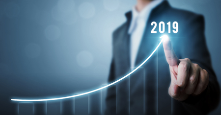 Business development to success in 2019 concept. Businessman pointing arrow graph corporate future...