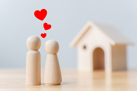 Wood doll couple lover with house. Family home, Insurance and property investment real estate conceptの写真素材