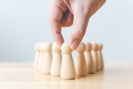 Human resource, Talent management, Recruitment employee, Successful business team leader concept. Hand chooses a wooden people standing out from the crowd.の写真素材