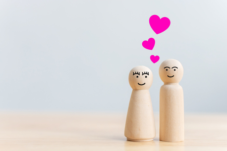 Valentine's day concept. Human wood couple lover with heart shape on tableの写真素材