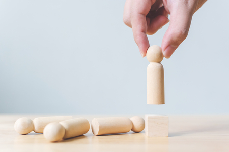 Human resource, Talent management, Recruitment employee, Successful business team leader concept. Hand chooses a wooden people standing out from the crowd.の写真素材