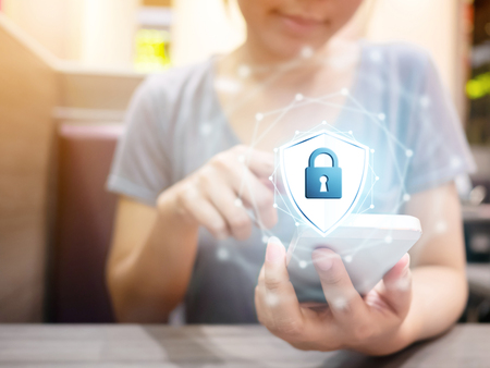 Woman using smartphone with icon graphic cyber security network of connected devices and personal data informationの写真素材