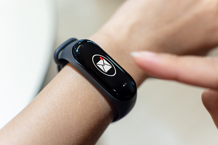 Close up image hand of male using smart watch with unread message icon on the screenの写真素材