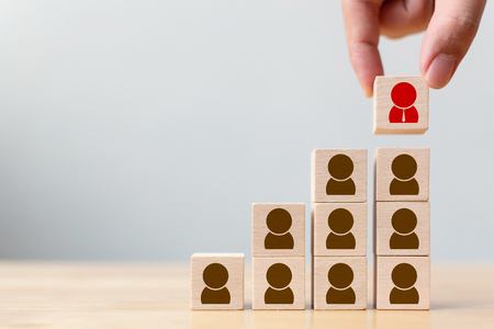Human resource and talent management and recruitment business concept, Hand putting wood cube block on top staircaseの写真素材