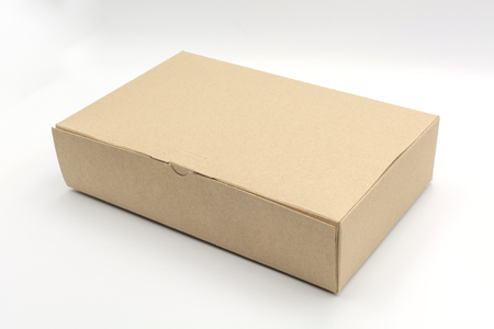Closed blank cardboard brown box isolated on white backgroundの写真素材