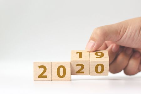 New year 2019 change to 2020 concept. Hand flip over wood cube blockの写真素材