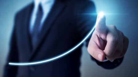 Business development to success and growing annual revenue growth concept, Businessman pointing arrow graph corporate future growth planの写真素材