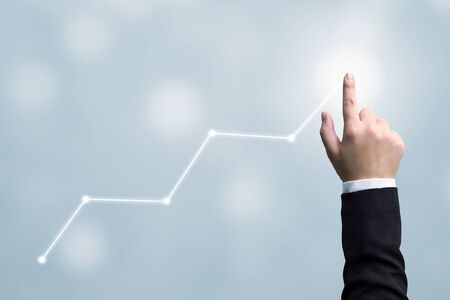 Business development to success and growing growth concept. Hand of businessman pointing arrow graph corporate future growth planの写真素材