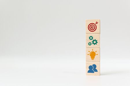 Concept of business strategy and action plan. Wood cube block stacking with icon on white backgroundの写真素材