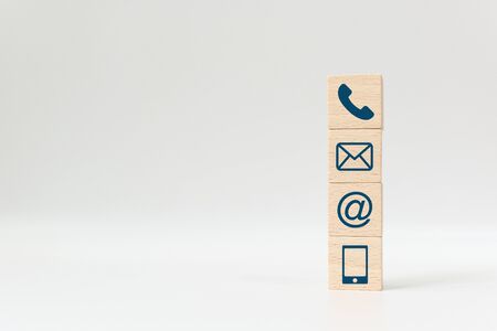 Wooden block cube symbol telephone, email, address and mobile phone. Website page contact us or e-mail marketing conceptの写真素材