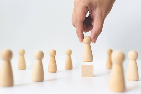Human resource, Talent management, Recruitment employee, Successful business team leader concept. Hand chooses a wooden people standing out from the crowd.の写真素材