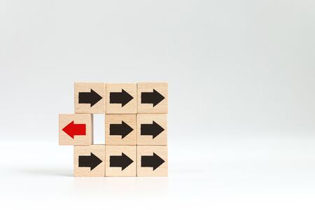Wooden block with red arrow facing the opposite direction black arrows, Unique, think different,...