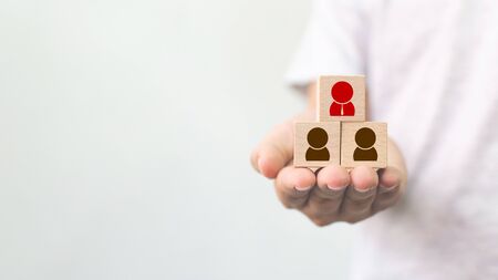 Human resource management and recruitment business concept, Hand holding wooden cube block on top...