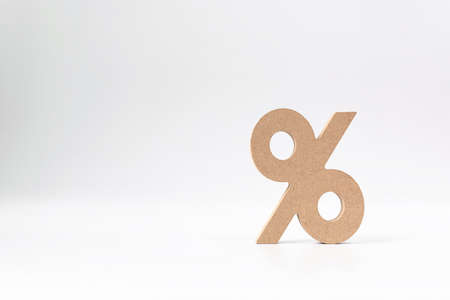 Interest rate concept. Percentage sign symbol icon wooden on white backgroundの写真素材