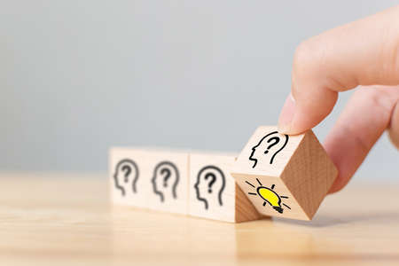 Concept creative idea and innovation. Hand puttung wooden cube block flip over with head human...
