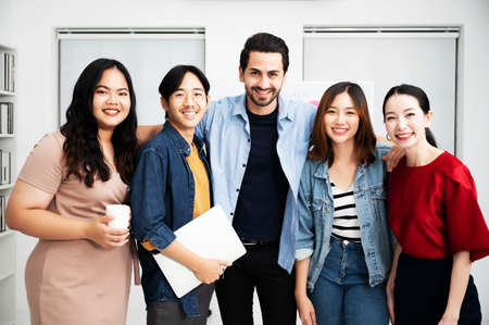 Portrait of business teamwork standing together feeling happy and smile. Multiethnic diverse people team entrepreneur startupの写真素材