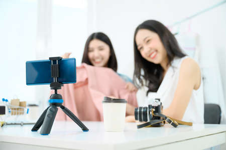 Two people young asian female recording video by smartphone.