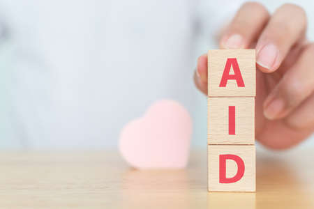 Wood block with word "AID" Healthcare medical and Insurance for your health conceptの写真素材