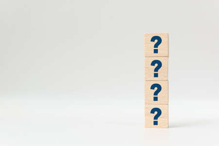 Wooden cube block shape with sign question mark symbol on white backgroundの写真素材