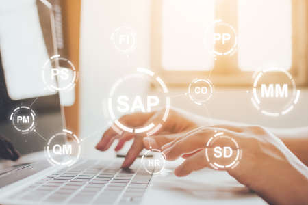 Close-up image of male hands working on laptop. Business management software (SAP). ERP enterprise resources planning system conceptの写真素材