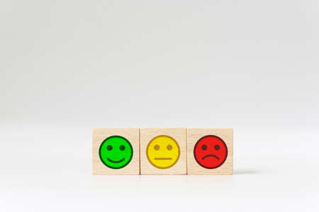 Emotional face on wooden block cube on white background, Excellence, Good, Bad. The best excellent business services rating customer experience, Satisfaction survey conceptの写真素材