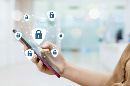 Female hand using mobile smart phone with icon graphic cyber security network of connected devices...