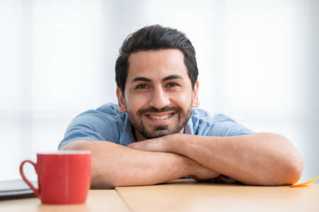 Young business man smiling and happy, relaxed in his spare time from work