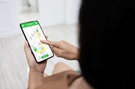 Woman using mobile smartphone with application deliveryの写真素材