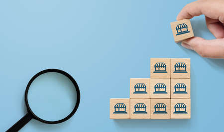Franchise business marketing system concept. Structure service store network strategy. Hand putting...