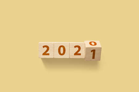 New year 2020 change to 2021. Wooden cube block flip over. New year resolution goal conceptの写真素材