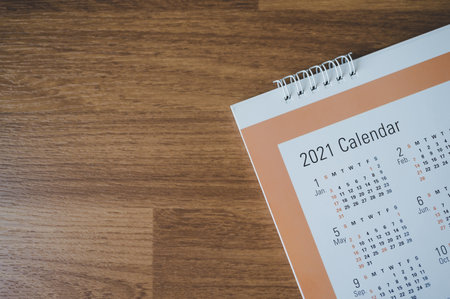 Top view with calendar 2021 month on wooden, Schedule to make appointment meeting or manage timetable each day for planning work and life conceptの写真素材