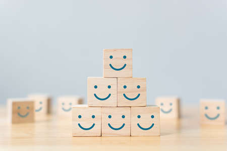 Wooden cube block shape with icon face smiley, The best excellent business services rating customer experience, Satisfaction survey conceptの写真素材