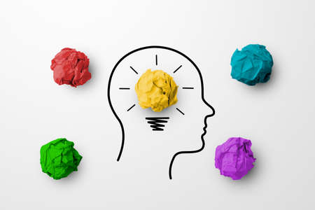 Concept creative idea and innovation. Paper scrap ball yellow colour outstanding different group with light bulb and head human symbolの写真素材