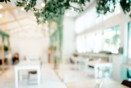 Blurred images of the coffee shop cafe interior background and lighting bokeh