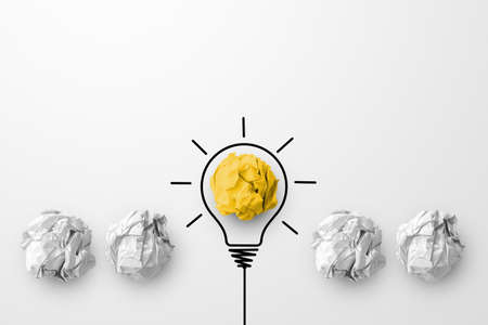Concept creative idea and innovation. Paper scrap ball yellow colour outstanding different group with light bulb symbolの写真素材