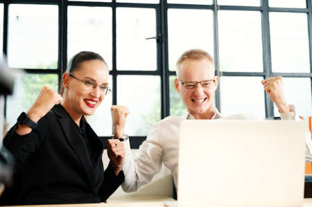 Business people group feeling euphoric celebrating online win success achievement result, man and woman happy about good news, motivated by great offer or new opportunityの写真素材
